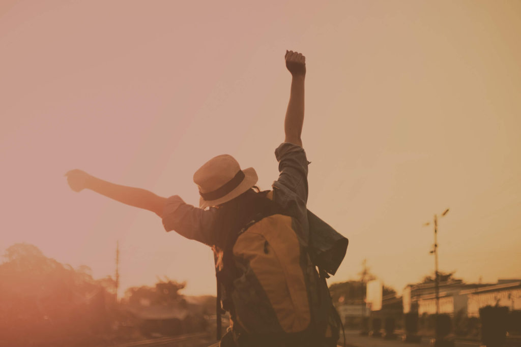 a young person walking away with both fists in the air