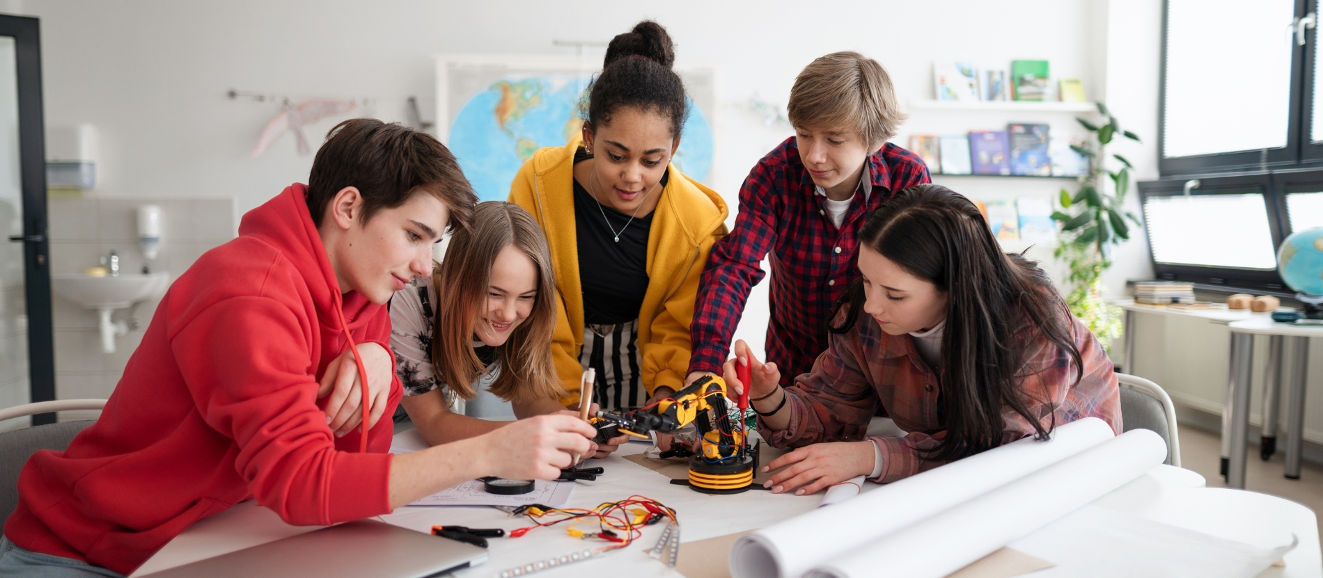 Students gathered around a table, working together
