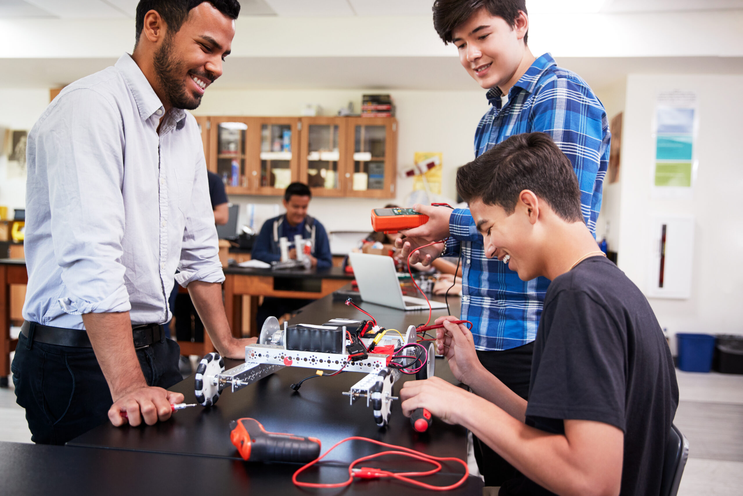 students with teacher in a science class