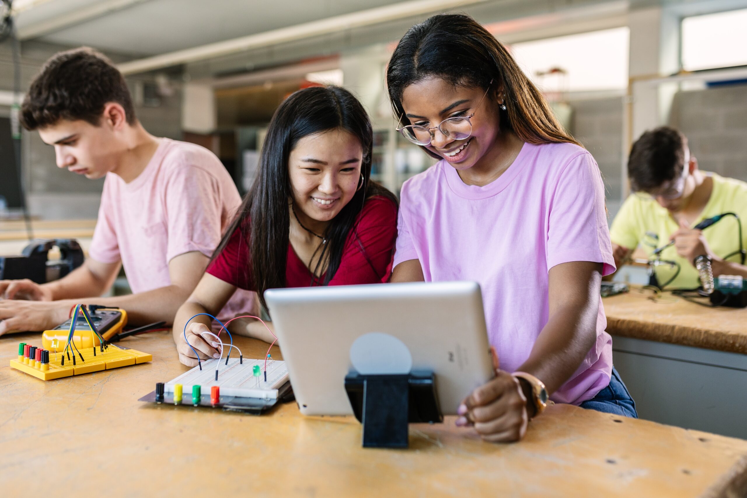 two female students working on an iPad together