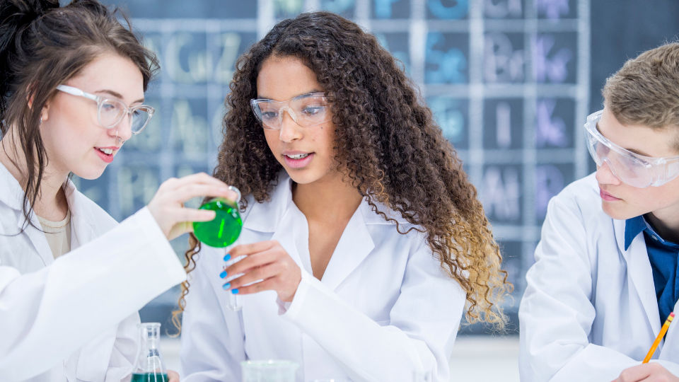 students in a science class wearing lab coats