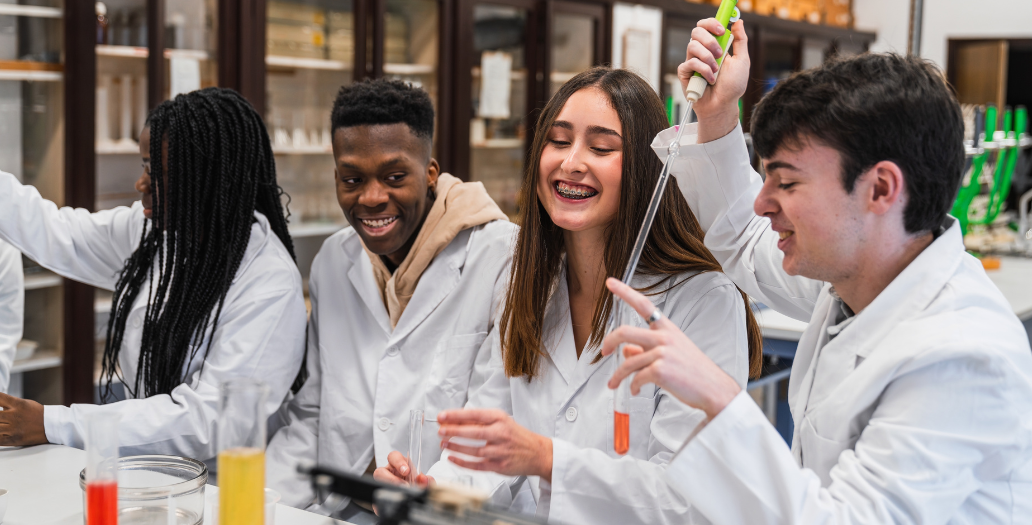 students smiling in a science lab