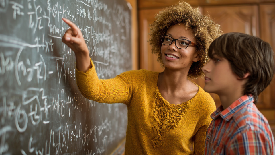 two students looking at math equations together
