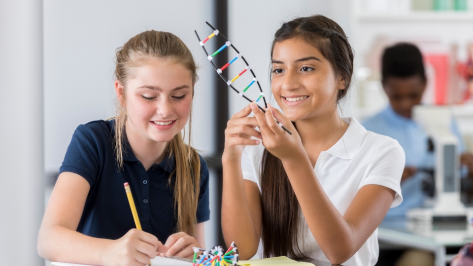 two middle school students working on a science project